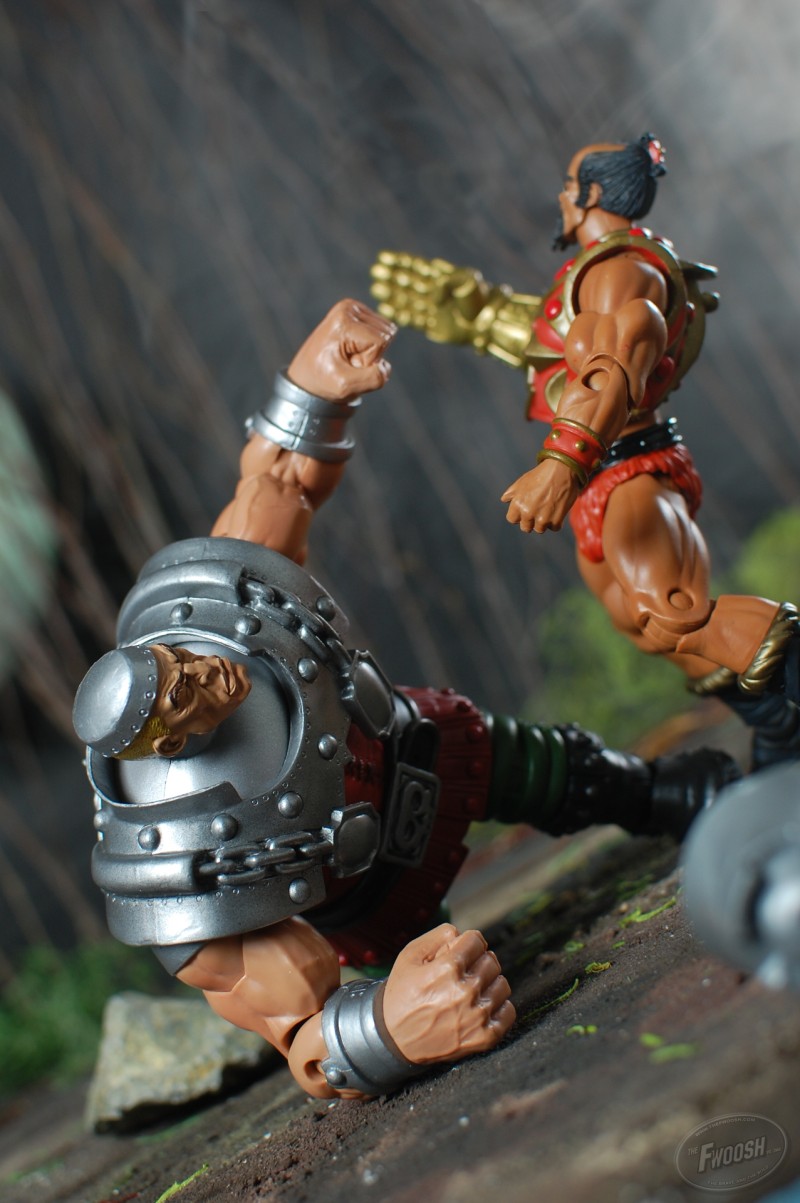 Even though Jitsu has knocked Ram Man's helmet off, he still has fight enough to bash Jitsu across the jaw.